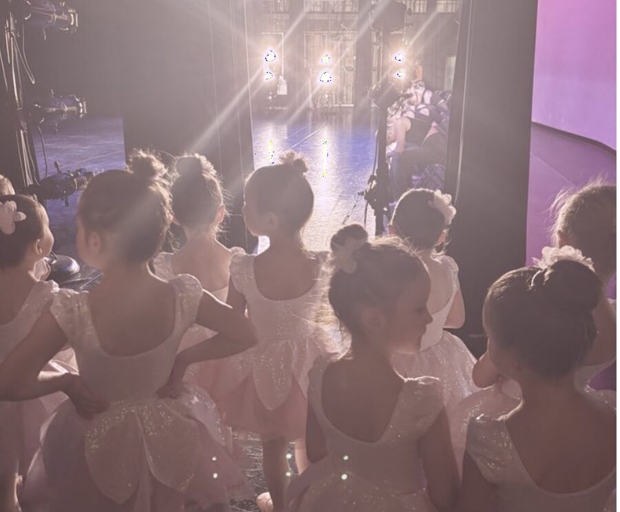 Young dancers watching from backstage before a recital